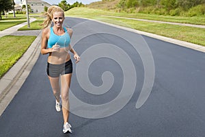 Beautiful Blond Woman Jogging With MP3 Player photo