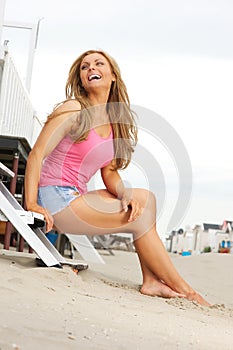 Beautiful blond woman laughing at the beach