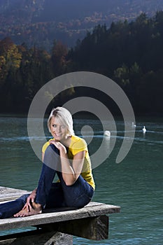 Beautiful blond woman relaxing at a lake