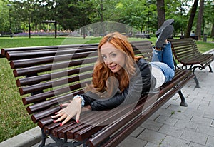 Beautiful blond woman sitting on bench