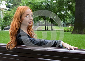 Beautiful blond woman sitting on bench