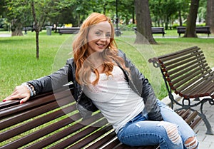 Beautiful blond woman sitting on bench