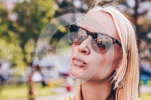 Beautiful blond woman in sun glasses give a kiss to you. Funny lifestile concept