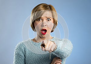 Beautiful blond woman in surprise and shock face expression expressing anxiety and fear