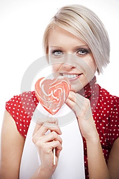 Beautiful blond woman with a Valentines lollipop