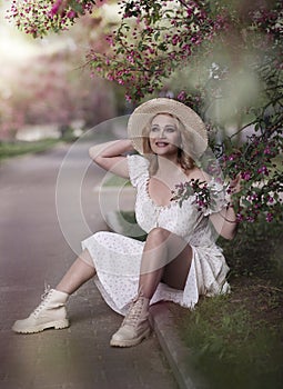 beautiful blond woman in white dress on lupin field summer background close up portrait