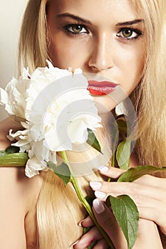 Beautiful blond woman with white flower