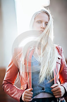 Beautiful blond woman with wind in her hair backlit by sunshine