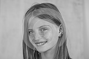 Beautiful blond young girl with freckles indoors , closeup portrait, , black and white