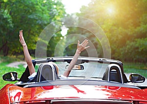 Beautiful blond young woman driving a sports car photo