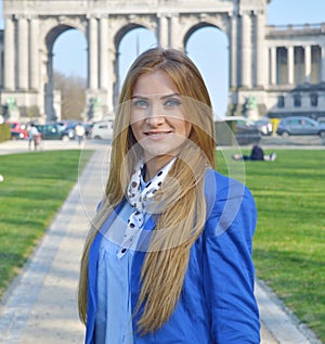 Beautiful blond young woman outdoors, smiling