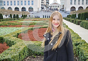 Beautiful blond young woman outdoors, smiling