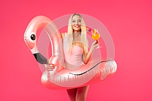 Beautiful blonde in a bathing suit with an inflatable flamingo