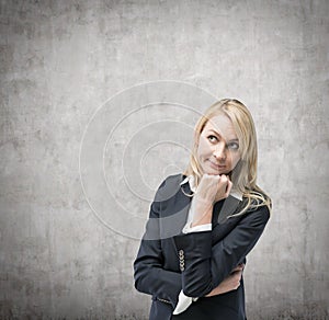 Beautiful blonde business woman is thinking about business issues.