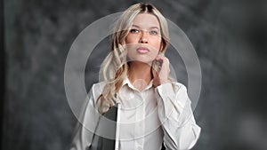 Beautiful blonde businesswoman boss ambitious leader portrait posing isolated on gray studio
