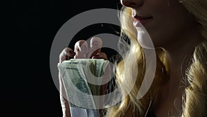 Beautiful blonde counting bundle of dollars, money for sex service, elite escort