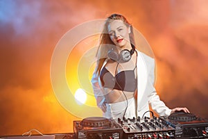 Beautiful blonde DJ girl on decks - the party