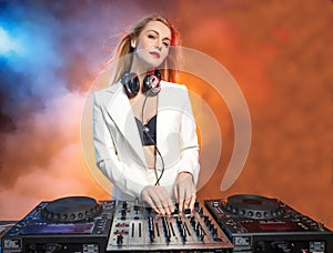 Beautiful blonde DJ girl on decks - the party