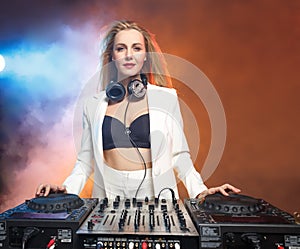 Beautiful blonde DJ girl on decks - the party