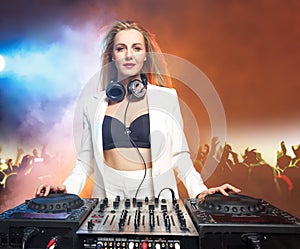Beautiful blonde DJ girl on decks - the party,