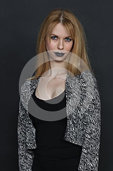 Beautiful blonde european girl with blue eyes posing in studio on isolated background. Style, trends, modeling, fashion concept.