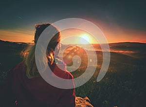 Beautiful blonde girl on background of morning mountains