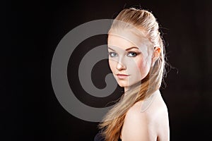 Beautiful blonde girl on a black background