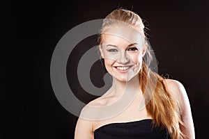 Beautiful blonde girl on a black background