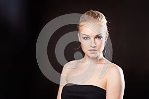 Beautiful blonde girl on a black background