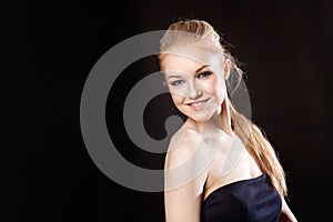 Beautiful blonde girl on a black background