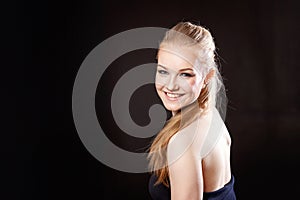 Beautiful blonde girl on a black background
