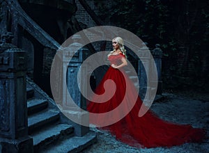 Beautiful blonde girl in a luxurious red dress