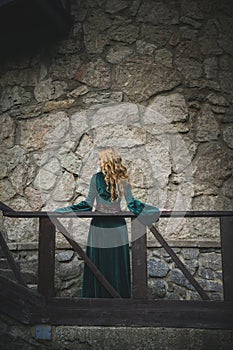 Beautiful blonde girl in the medieval dress with green sleeves