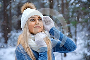 Beautiful blonde girl in red hat and gloves