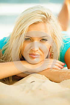 Beautiful blonde girl relaxing on beach