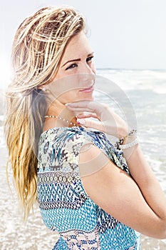 Beautiful blonde girl with sea background. Sweet attitude