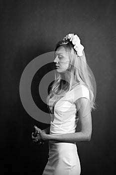 Beautiful blonde girl in the studio. Looking away