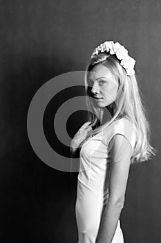 Beautiful blonde girl in the studio. Looking away