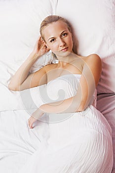 Beautiful blonde girl in white nightgown