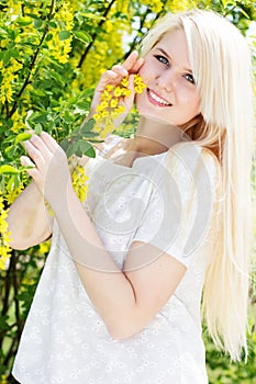 Beautiful blonde girl with yellow flowers