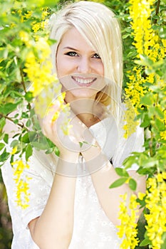 Beautiful blonde girl with yellow flowers