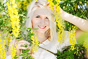 Beautiful blonde girl with yellow flowers