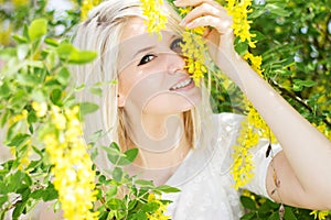 Beautiful blonde girl with yellow flowers