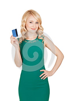 Beautiful blonde in a green dress holds a card