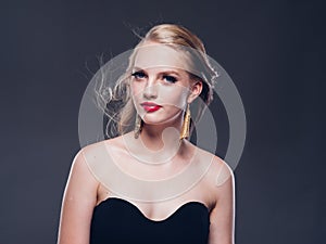 Beautiful blonde hair woman classic style with red lips and eyarrings and evening dress female portrait