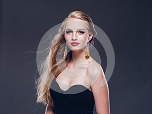 Beautiful blonde hair woman classic style with red lips and eyarrings and evening dress female portrait