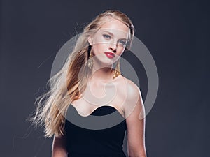 Beautiful blonde hair woman classic style with red lips and eyarrings and evening dress female portrait