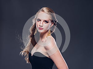 Beautiful blonde hair woman classic style with red lips and eyarrings and evening dress female portrait