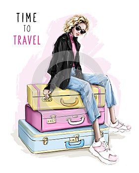 Beautiful blonde hair woman sitting on suitcases. Fashion girl in sunglasses.