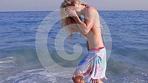 Beautiful blonde having fun into the sea